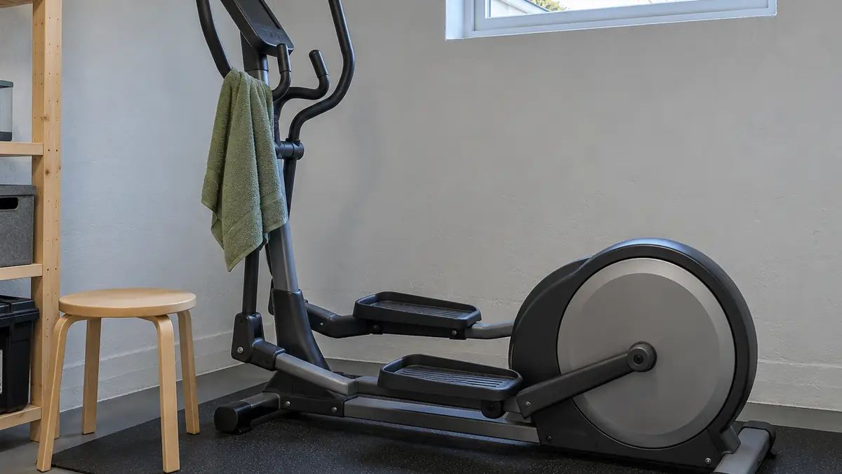 Crosstrainer på en gummimåtte i et kælderrum